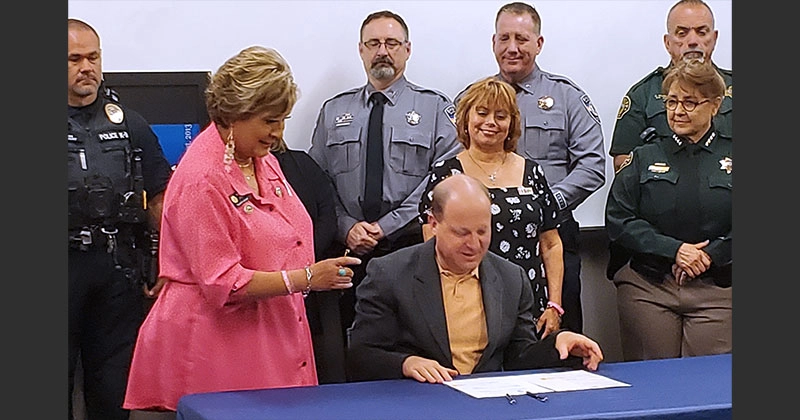 Governor Jared Polis signs greyhound simulcast ban with Majority Leader Monica Duran and GREY2K President Christine Dorchak (June 2, 2023)